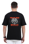Model wearing black oversized men’s t-shirt – bold “Fearless” back print streetwear design