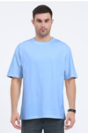 Model wearing blue oversized men’s t-shirt – Flux graphic cotton streetwear tee front view