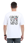Model wearing white oversized men’s t-shirt – “Grow Your Mind” graphic back print streetwear design